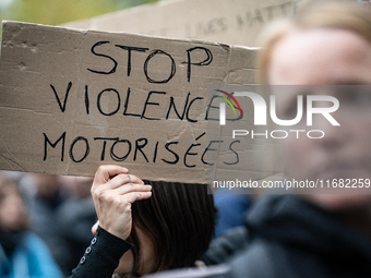 A demonstrator holds a sign reading ''Stop motorised violence'' during a gathering at the Place de La Republique in Paris, France, on Octobe...