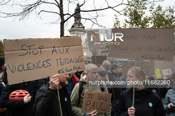 Demonstrators hold signs reading ''Stop motorised violence'' and ''road rage kills our children'' during a gathering at the Place de La Repu...