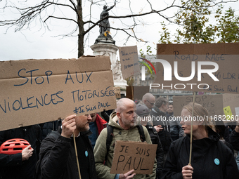 Demonstrators hold signs reading ''Stop motorised violence'' and ''road rage kills our children'' during a gathering at the Place de La Repu...