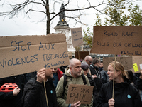 Demonstrators hold signs reading ''Stop motorised violence'' and ''road rage kills our children'' during a gathering at the Place de La Repu...