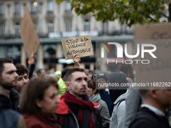 A demonstrator holds a sign reading ''Stop car violence'' during a gathering at the Place de La Republique in Paris, France, on October 19,...