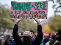 A man holds a sign reading ''serial killers'' during a gathering at the Place de La Republique in Paris, France, on October 19, 2024, to pay...