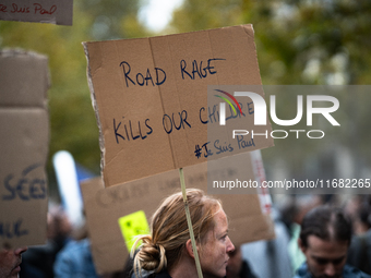 A woman holds a sign reading ''road rage kills our children'' during a gathering at the Place de La Republique in Paris, France, on October...