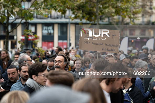 A man holds a sign reading ''police officers don't let us down stop motorised violence'' during a gathering at the Place de La Republique in...