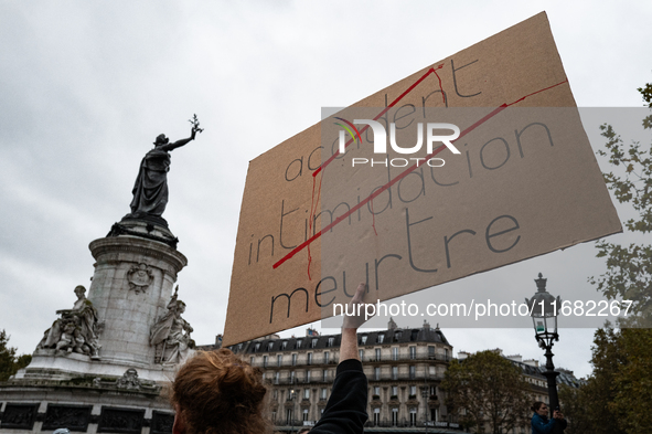 A man holds a sign reading ''Accident (crossed), intimidation (crossed) and murder'' during a gathering at the Place de La Republique in Par...