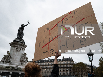 A man holds a sign reading ''Accident (crossed), intimidation (crossed) and murder'' during a gathering at the Place de La Republique in Par...