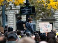 A demonstrator holds a sign reading ''make love not war'' during a gathering at the Place de La Republique in Paris, France, on October 19,...