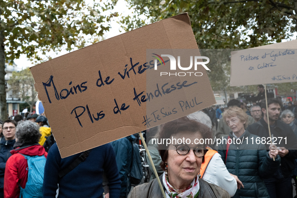 A woman holds a sign reading ''less speed more tenderness'' during a gathering at the Place de La Republique in Paris, France, on October 19...