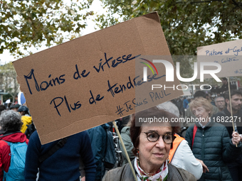 A woman holds a sign reading ''less speed more tenderness'' during a gathering at the Place de La Republique in Paris, France, on October 19...