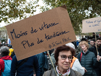 A woman holds a sign reading ''less speed more tenderness'' during a gathering at the Place de La Republique in Paris, France, on October 19...