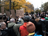 A man holds a sign reading ''I am Paul'' during a gathering at the Place de La Republique in Paris, France, on October 19, 2024, to pay trib...