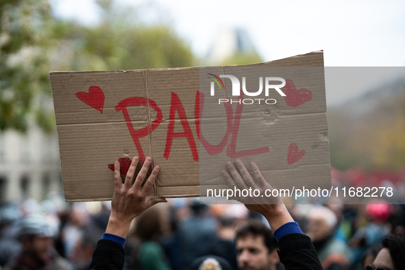 A man holds a sign reading ''Paul'' during a gathering at the Place de La Republique in Paris, France, on October 19, 2024, to pay tribute t...