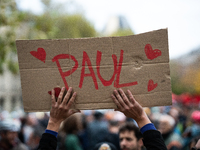 A man holds a sign reading ''Paul'' during a gathering at the Place de La Republique in Paris, France, on October 19, 2024, to pay tribute t...