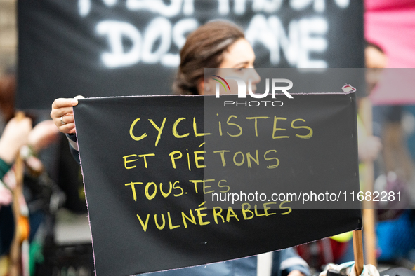 A demonstrator holds a banner reading ''cyclists and pedestrians all vulnerable'' during a gathering at the Place de La Republique in Paris,...