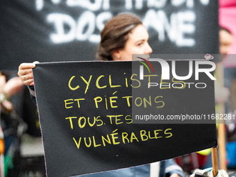 A demonstrator holds a banner reading ''cyclists and pedestrians all vulnerable'' during a gathering at the Place de La Republique in Paris,...