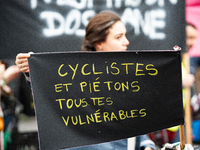 A demonstrator holds a banner reading ''cyclists and pedestrians all vulnerable'' during a gathering at the Place de La Republique in Paris,...