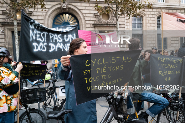 A demonstrator holds a banner reading ''cyclists and pedestrians all vulnerable'' during a gathering at the Place de La Republique in Paris,...