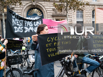 A demonstrator holds a banner reading ''cyclists and pedestrians all vulnerable'' during a gathering at the Place de La Republique in Paris,...