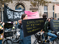 A demonstrator holds a banner reading ''cyclists and pedestrians all vulnerable'' during a gathering at the Place de La Republique in Paris,...