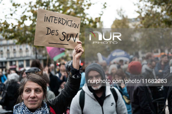 A demonstrator holds a sign reading ''Ban SUV'' during a gathering at the Place de La Republique in Paris, France, on October 19, 2024, to p...