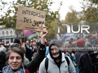 A demonstrator holds a sign reading ''Ban SUV'' during a gathering at the Place de La Republique in Paris, France, on October 19, 2024, to p...