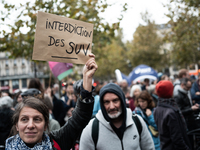 A demonstrator holds a sign reading ''Ban SUV'' during a gathering at the Place de La Republique in Paris, France, on October 19, 2024, to p...