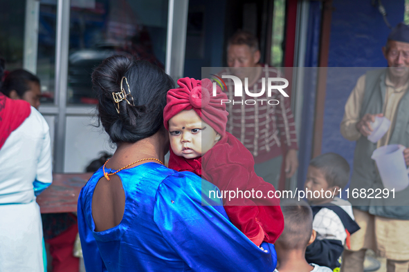 A health worker gives a Vitamin A capsule to a child in Dhading, Nepal, on October 19, 2024. 