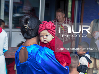 A health worker gives a Vitamin A capsule to a child in Dhading, Nepal, on October 19, 2024. (