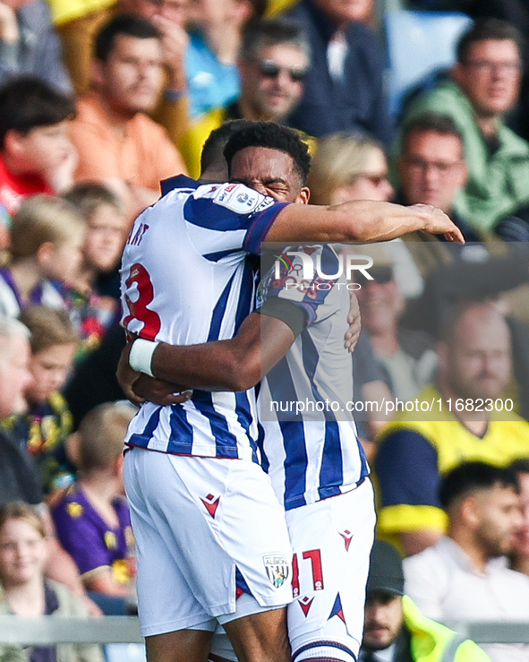 Number 18, Karlan Grant of WBA, is hugged by number 11, Grady Diangana, during the Sky Bet Championship match between Oxford United and West...