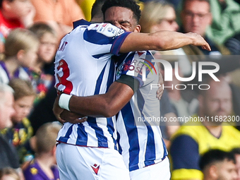 Number 18, Karlan Grant of WBA, is hugged by number 11, Grady Diangana, during the Sky Bet Championship match between Oxford United and West...