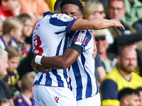 Number 18, Karlan Grant of WBA, is hugged by number 11, Grady Diangana, during the Sky Bet Championship match between Oxford United and West...