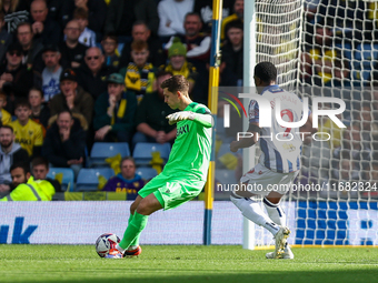 Jamie Cunningham of Oxford clears the ball under pressure from Josh Maja of WBA during the Sky Bet Championship match between Oxford United...