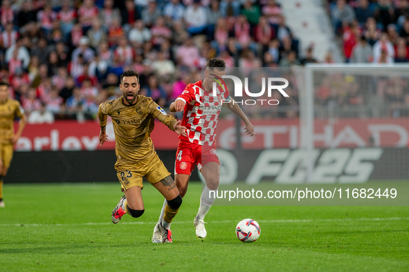 Arnau Martinez of Girona FC and Brais Mendez of Real Sociedad compete for the ball during the LaLiga Hypermotion 2024-2025 match between Gir...