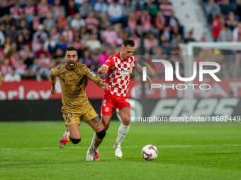 Arnau Martinez of Girona FC and Brais Mendez of Real Sociedad compete for the ball during the LaLiga Hypermotion 2024-2025 match between Gir...