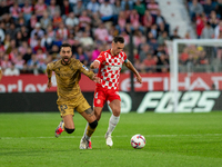 Arnau Martinez of Girona FC and Brais Mendez of Real Sociedad compete for the ball during the LaLiga Hypermotion 2024-2025 match between Gir...