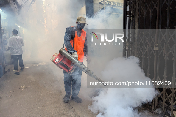 A worker sprays pesticide to kill mosquitoes in the capital city in Dhaka, Bangladesh, on October 19, 2024. The statement adds that this yea...