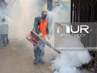 A worker sprays pesticide to kill mosquitoes in the capital city in Dhaka, Bangladesh, on October 19, 2024. The statement adds that this yea...