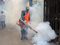 A worker sprays pesticide to kill mosquitoes in the capital city in Dhaka, Bangladesh, on October 19, 2024. The statement adds that this yea...