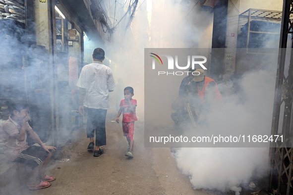 A worker sprays pesticide to kill mosquitoes in the capital city in Dhaka, Bangladesh, on October 19, 2024. The statement adds that this yea...