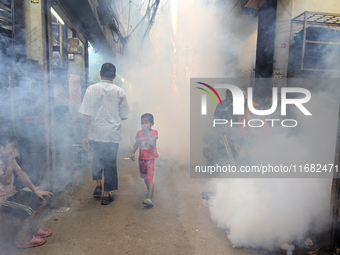 A worker sprays pesticide to kill mosquitoes in the capital city in Dhaka, Bangladesh, on October 19, 2024. The statement adds that this yea...