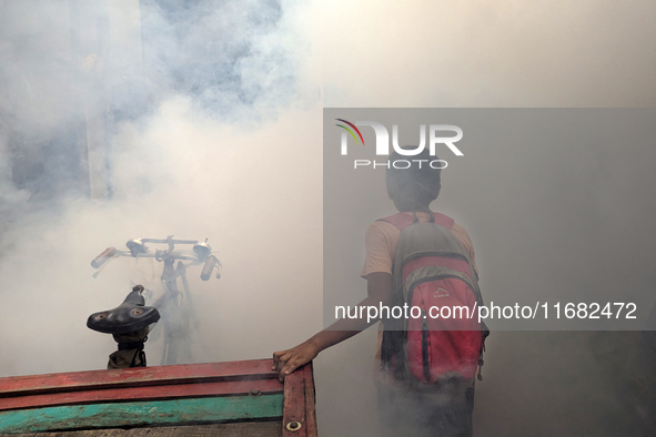 A worker sprays pesticide to kill mosquitoes in the capital city in Dhaka, Bangladesh, on October 19, 2024. The statement adds that this yea...