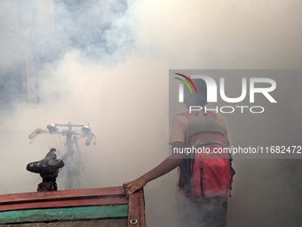 A worker sprays pesticide to kill mosquitoes in the capital city in Dhaka, Bangladesh, on October 19, 2024. The statement adds that this yea...