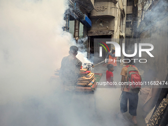 A worker sprays pesticide to kill mosquitoes in the capital city in Dhaka, Bangladesh, on October 19, 2024. The statement adds that this yea...