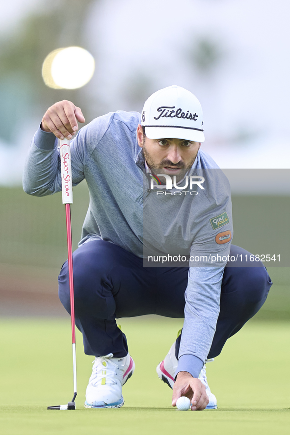 In San Roque, Spain, on October 19, 2024, Antoine Rozner of France studies his shot on the 1st green on the third day of the Estrella Damm N...