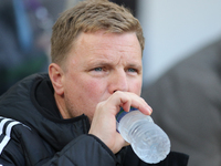 Newcastle United Manager Eddie Howe drinks from a bottle of water during the Premier League match between Newcastle United and Brighton and...