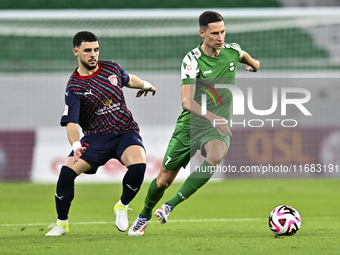 Bassam Hisham of Al Duhail FC battles for the ball with Julian Draxler of Al Ahli SC during the Ooredoo Qatar Stars League 24/25 match betwe...