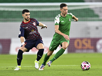 Bassam Hisham of Al Duhail FC battles for the ball with Julian Draxler of Al Ahli SC during the Ooredoo Qatar Stars League 24/25 match betwe...