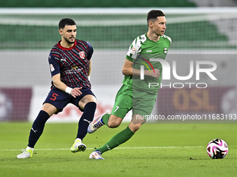 Bassam Hisham of Al Duhail FC battles for the ball with Julian Draxler of Al Ahli SC during the Ooredoo Qatar Stars League 24/25 match betwe...