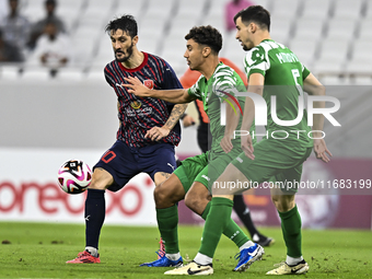 Luis Alberto of Al Duhail FC battles for the ball with Matej Mitrovic of Al Ahli SC during the Ooredoo Qatar Stars League 24/25 match betwee...