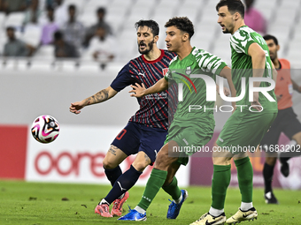 Luis Alberto of Al Duhail FC battles for the ball with Matej Mitrovic of Al Ahli SC during the Ooredoo Qatar Stars League 24/25 match betwee...